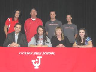 Jackson High School's Payton Ervin is joined by family, friends and coaches after signing with the University of Rio Grande.